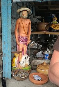 Saint of an old guy with chest naked, two dogs and a clutch, wearing mochila for a trip.